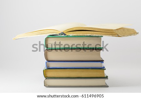 Many closed books lying on a white background.One open book.Horizontal.
