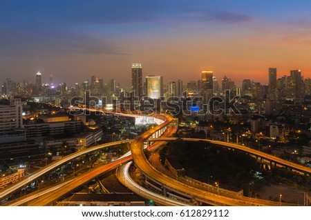 Beautiful sunset sky background over city highway overpass interchanged and business downtown background