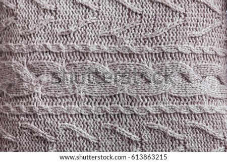 Beautiful gray knitted pattern, knitted scarf close up. Knitted background