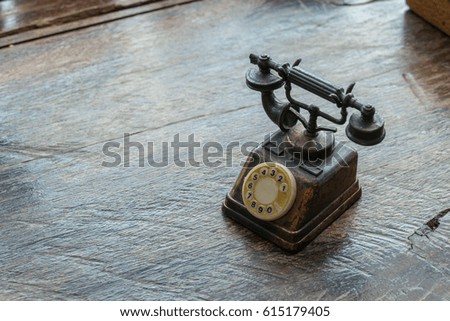 Classic home telephone model on wood background