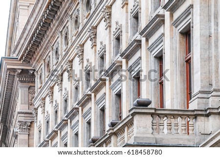 Row of marble columns with dark gaps as classical architectural details with rhythm of Prague National Theater