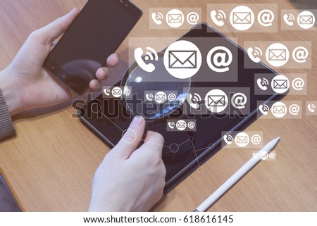 Businessman using tablet with magnifying glass search mail. Looks at the account support web email.