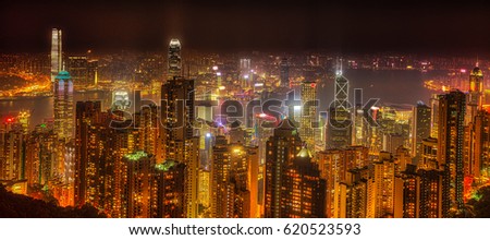 Panorama of Hong Kong, China. Spectacular night view of Victoria Harbour skyline from Victoria Peak. The Peak is the highest mountain in Hong Kong Island.