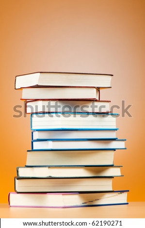 Stack of text books against gradient background