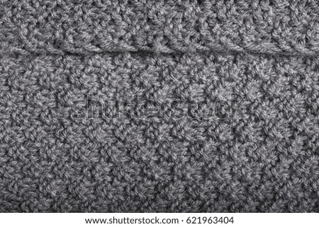 details of knitted hand made gray cashmere wool fabric, textile background.