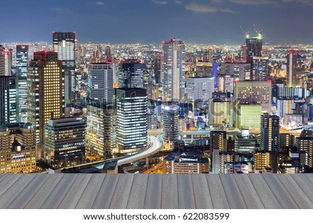 Opening wooden floor, city of Osaka aerial view at night, Japan