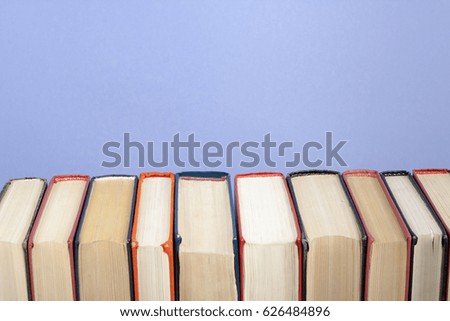 .Stack of books on colorful wall background. Copy space for text.Back to school. Education concept.