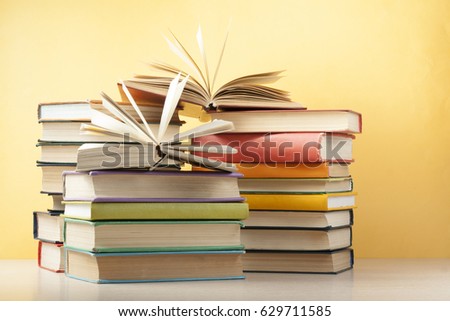 Open book, hardback books on wooden table. Education background. Back to school.