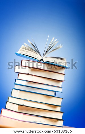 Stack of text books against gradient background