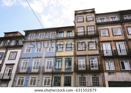 Facades of old colorful different houses in touristic district, Porto, Portugal.
