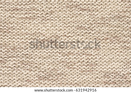 Knitted cloth purl stitch texture of melange neutral colored linen yarn.
