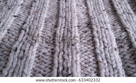 Grey knitted wool background. Vertical lines.
