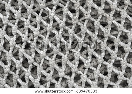 The meshes of a gray fishing net