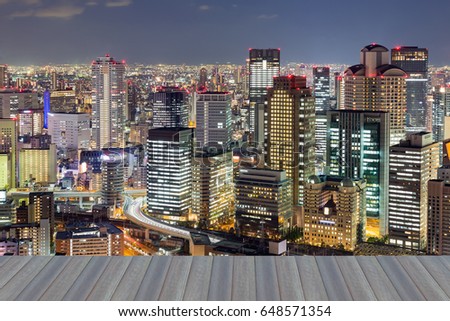 Opening wooden floor, Osaka city business downtown aerial view at night, Japan
