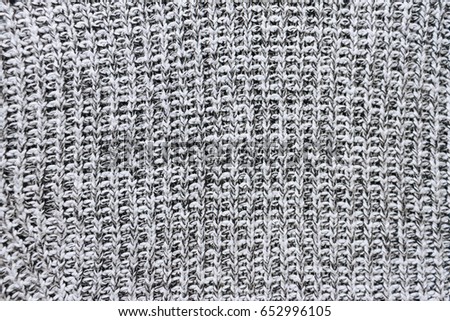 Gray and white knitted flat lay texture background. Close up pattern