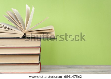 Open book, hardback books on wooden table. Back to school. Copy space for text. Education background.