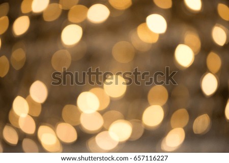 Bokeh is a golden color, the glitter of lights is the background. Defocused.