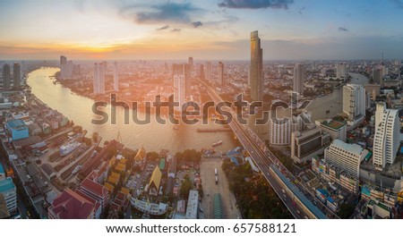 Sunset skyline over Bangkok city panorama over river curved, Thailand