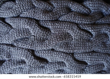 Close up of plait pattern on grey knit fabric