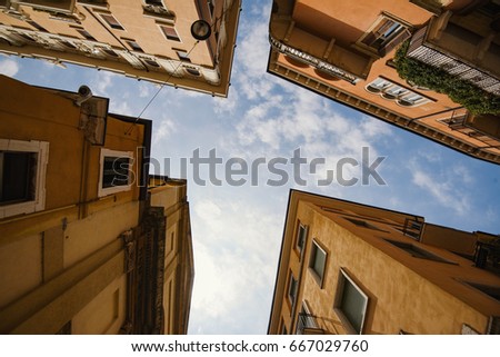 Building with traditional architecture on a narrow street in Verona, Italy.