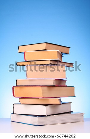 Books pile on the table and yellow background