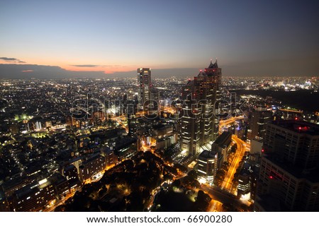 High-rising buildings lighting up during sunset in Tokyo, Japan