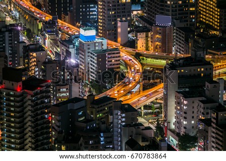 Car traffic on highway at roppongi district at night in tokyo japan