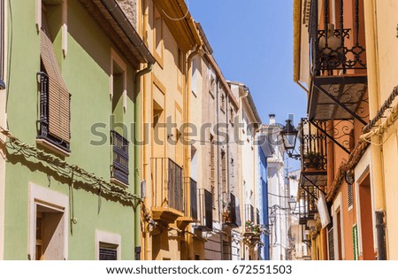 Colorful houses in a narrow street in Ayora, Spain