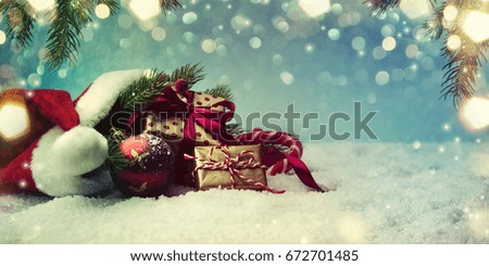 Christmas gift box and holidays lights on blue background.