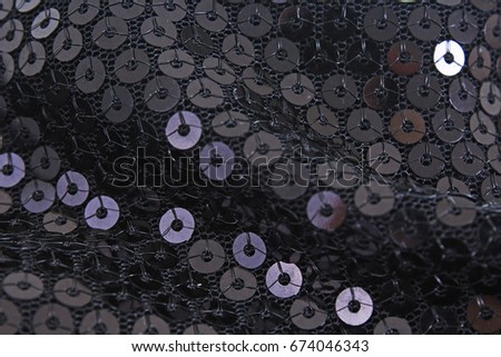 Spangle, sequin pailette background. Mirror dress material cloth texture pattern. Tailoring stitching concept. Shiny mirrored fashion fabric. Shiny clothing material sample. Black sequin fabric.
