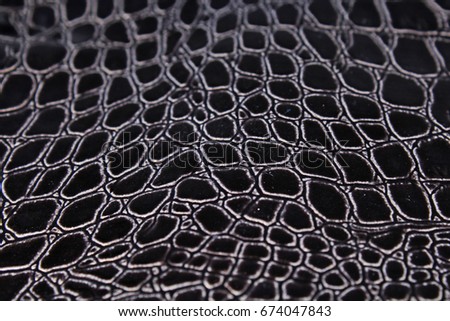 Snake skin faux fashion fabric. Close up snake leather texture.