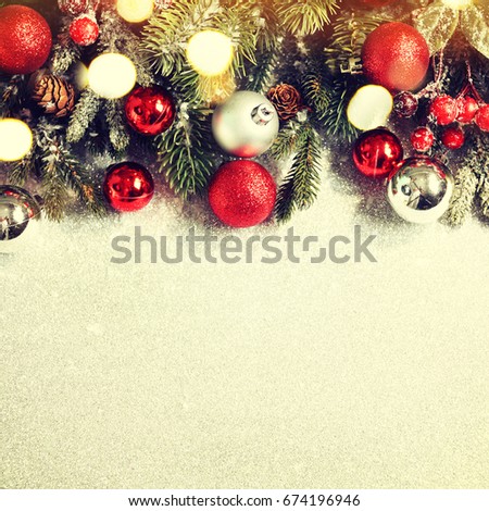 Christmas card with fir and decor on glitter background