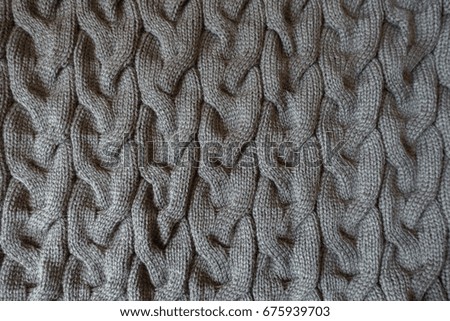 Grey knit fabric with plait pattern from above