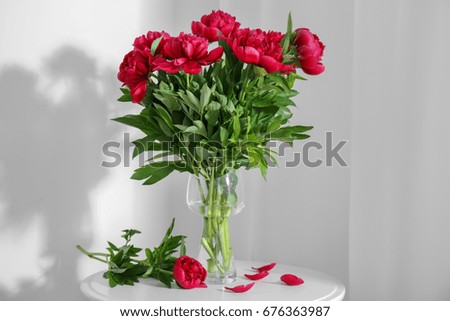 Bouquet of beautiful peony flowers on table