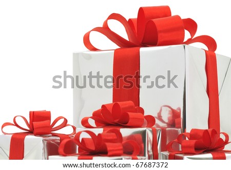 Gifts in silver wrapping with red bow isolated on white background