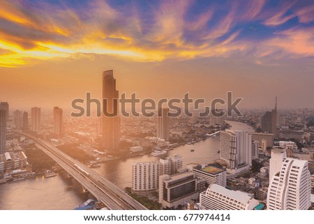 Beautiful sunset sky over Bangkok city river curved aerial view, cityscape downtown background, Thailand