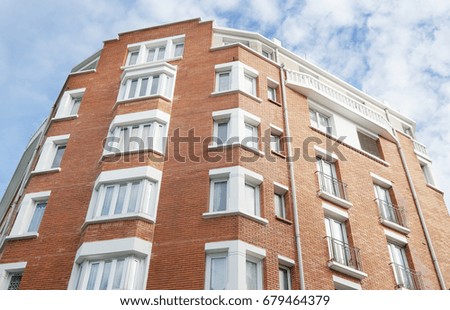 Modern building with windows on sky background