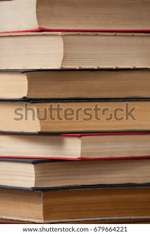 Close-up of stack of books against blue wooden background