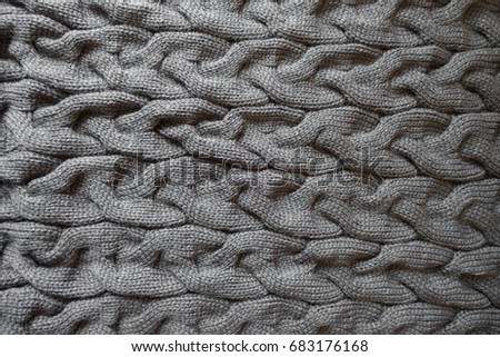 Horizontal plaits on grey knit fabric from above