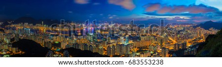 Hong Kong city skyline at sunset and twilight, panorama view Kowloon public pier, the cityscape of business and financial district, one of the world's most significant financial centres, Asia-Pacific