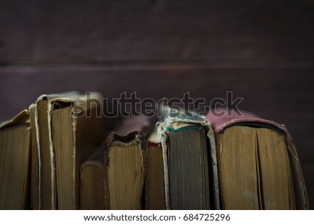 Very beautiful image with aged books on a wooden background