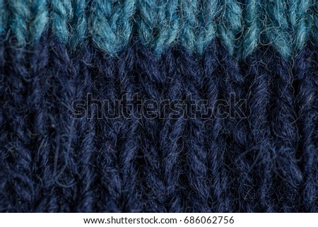 A beautiful closeup of a hand knitted warm and soft wool pattern. Soft socks or scarf of natural wool. Colorful pattern.