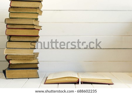 Open book on an white wooden table. Beautiful background.