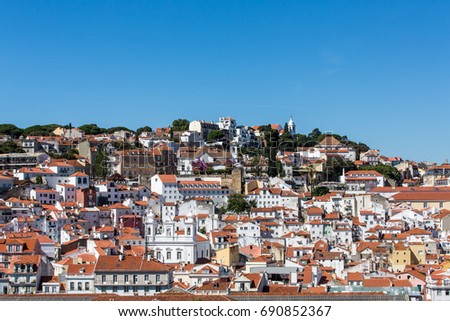 Colorful buildings and red tile rooftops on hills of Lisbon Portugal