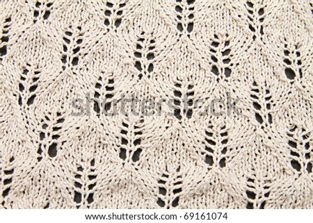a beige knitted fabric. a close up.