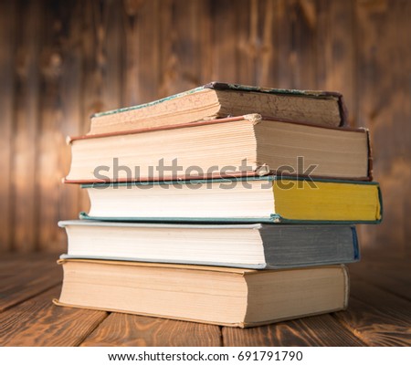 Stack of books on a wooden table
