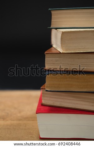 Close-up of book stack on wooden table