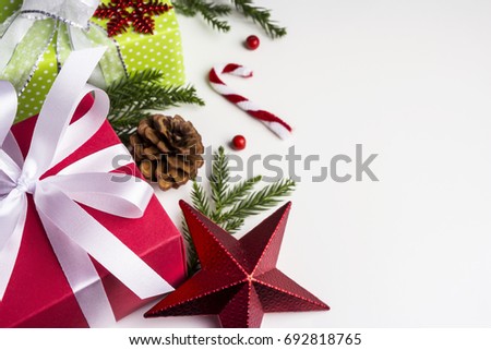 Christmas and New year decoration of gift box and pine leaves and pine cone on paper white background with copy space