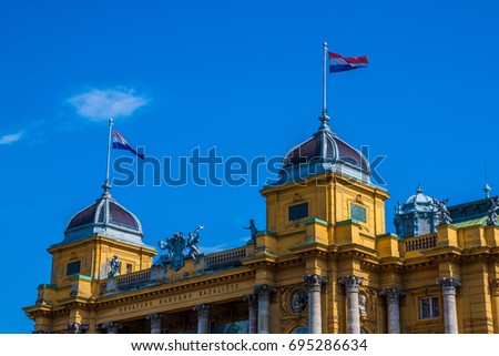 Republic of Croatia flag in Croatian National Theater on sunny day in Zagreb.