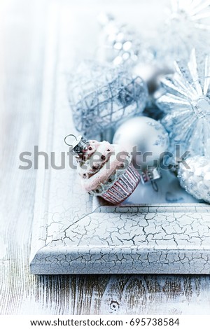 Christmas ornaments on a white frame. Christmas background. Symbolic image. Bright wooden background. Close up. Copy space.    
